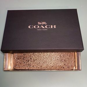Coach Golden glitter wristlet with black stars